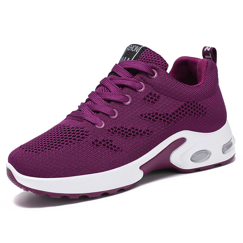 Plum trainers, side view on a plain background