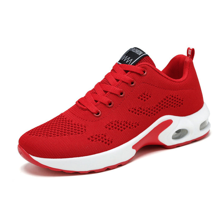 Red trainers, side view on a plain background