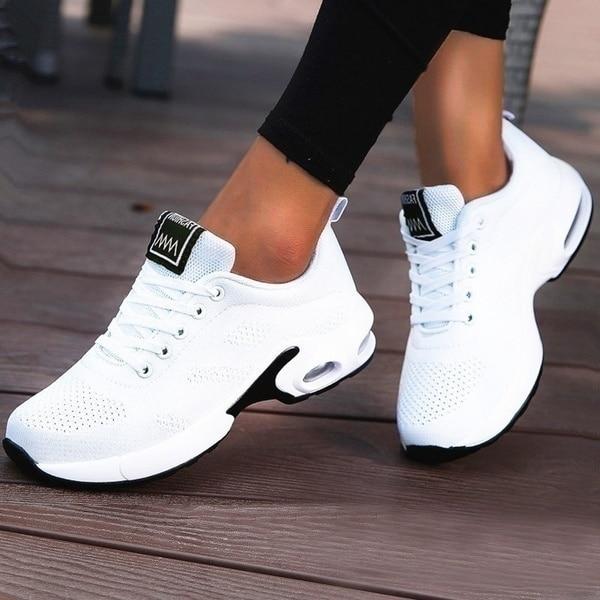 White trainers, worn on foot, front view
