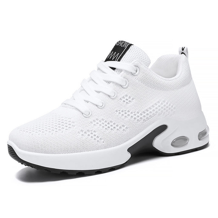 White trainers, side view on a plain background