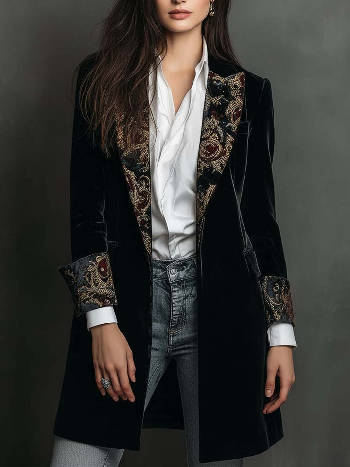 Black longline velvet jacket worn open over a white shirt
