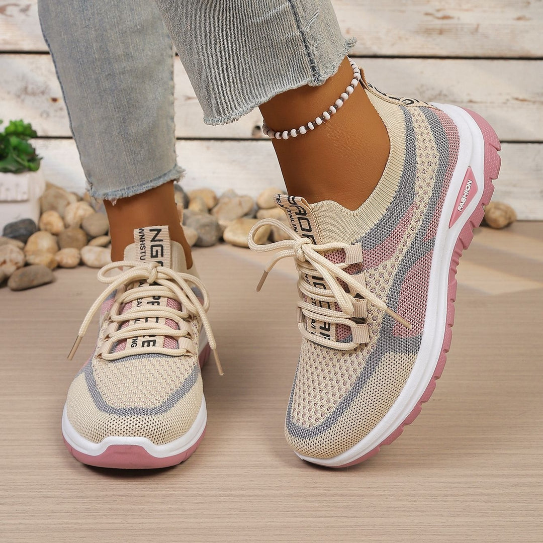 Beige Pink walking trainers, worn on foot, walking pose