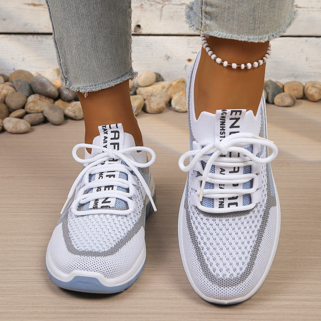White Blue walking trainers, worn on foot, walking pose
