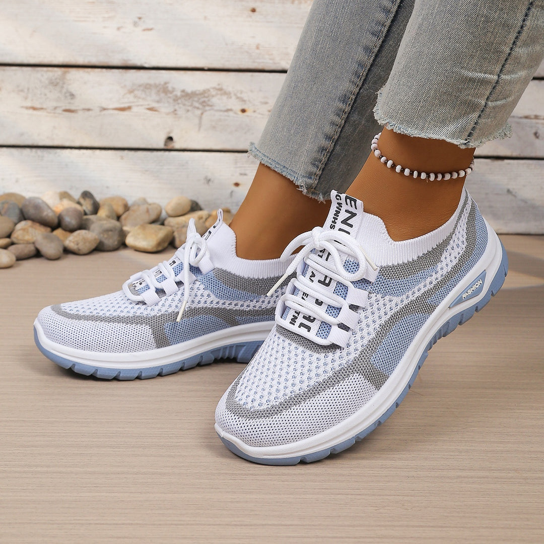 White Blue walking trainers, worn on foot, front view