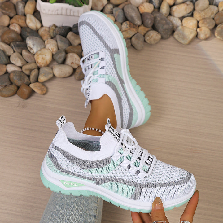 White Green walking trainers, worn on foot, side view