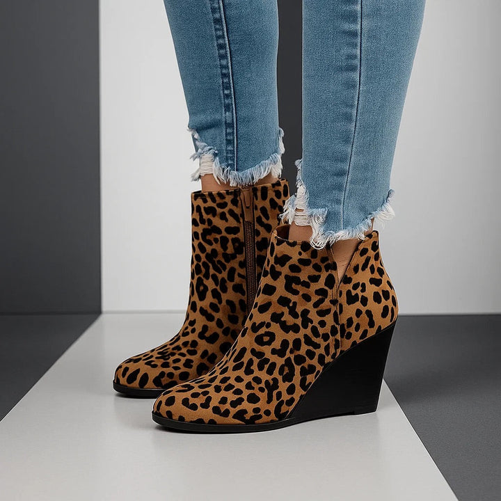 Pair of leopard print boots worn with light blue cropped trousers