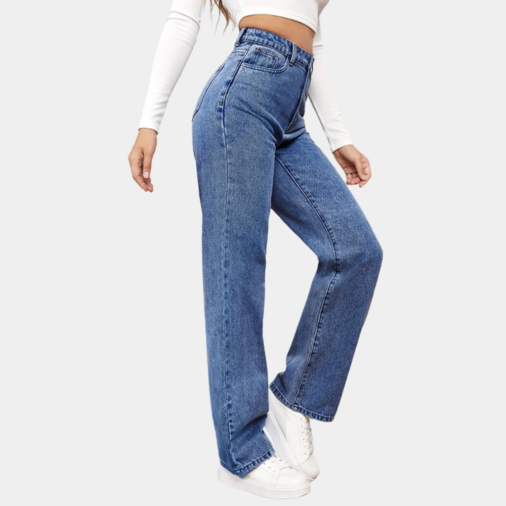 Mid blue high waisted jeans from the side, showing the wide leg