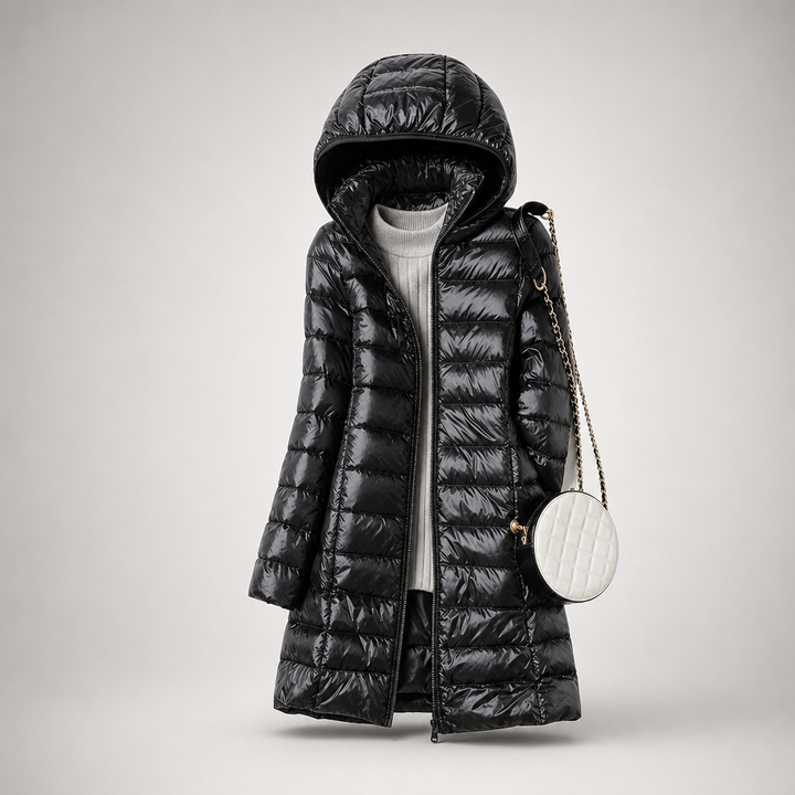 Black long hooded padded coat with glossy quilted channels and a white round bag