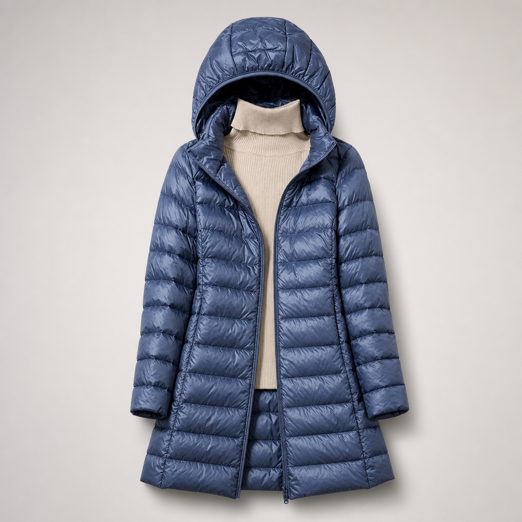 Blue long hooded padded coat worn open over a cream roll neck