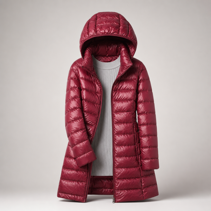 Burgundy long hooded padded coat worn open over a white jumper