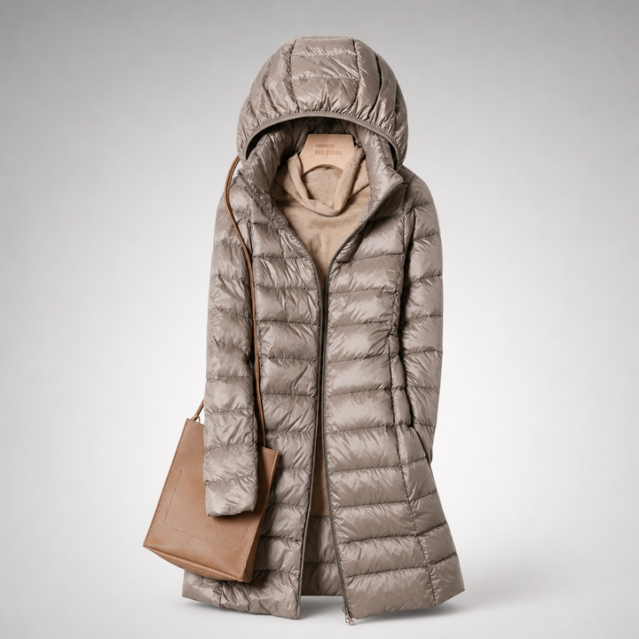 Khaki long hooded padded coat with a tan bag, shown from the front