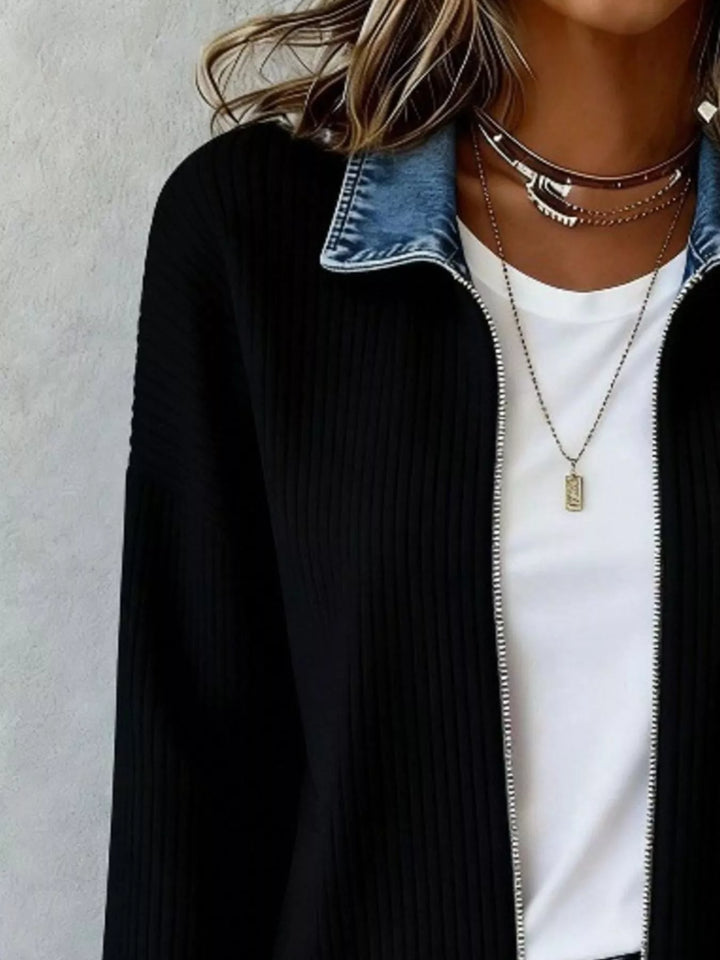 Close up of the black ribbed knit and contrast collar with silver zip