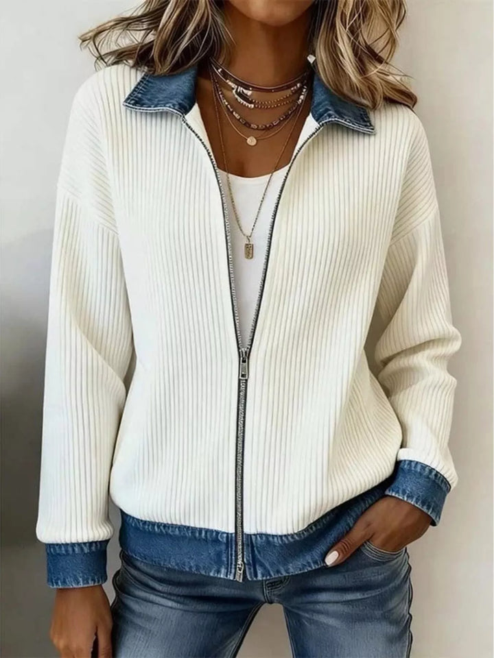 Cream ribbed cardigan jacket worn open over a white tee with layered necklaces